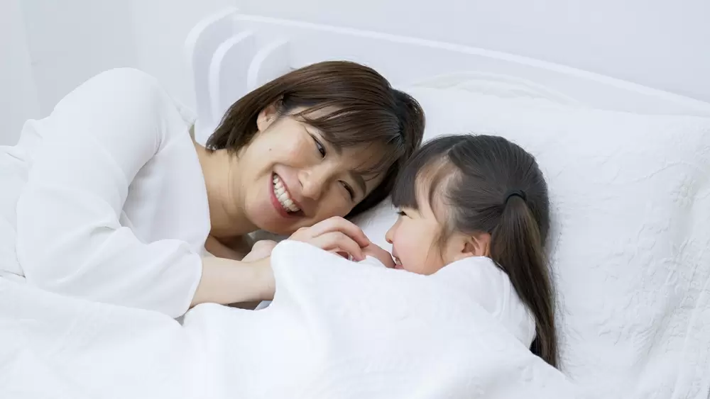 ベッドで会話をする親子