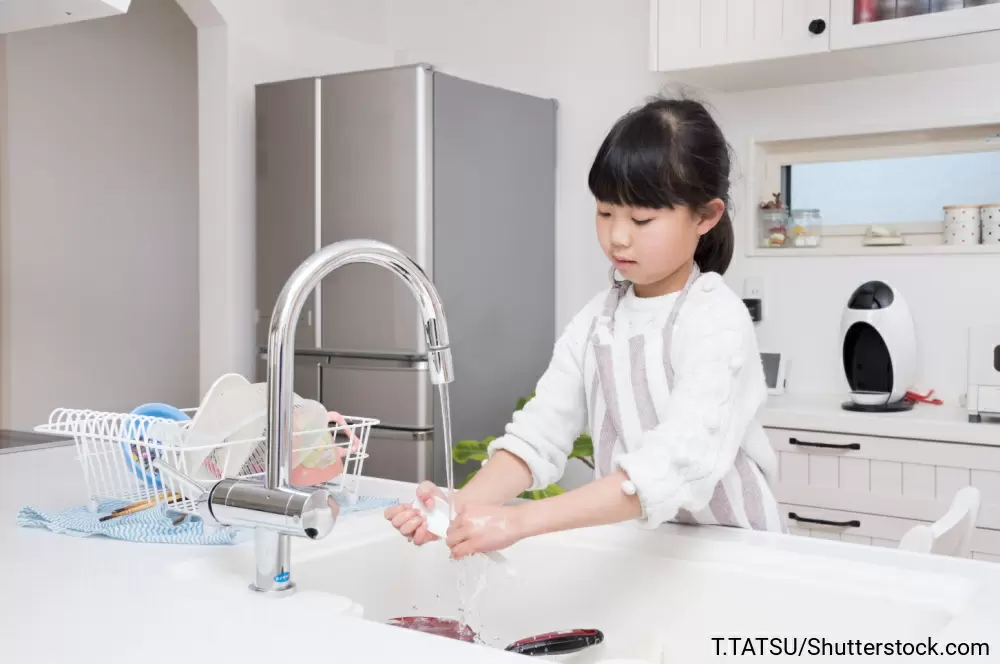 流しで食器を洗う女の子