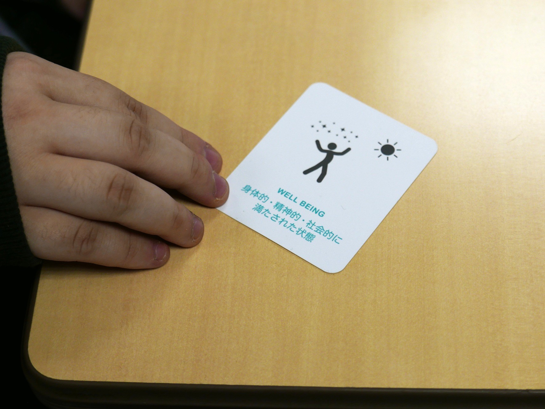 卒業生が手にしている「WELL BEING」のカード